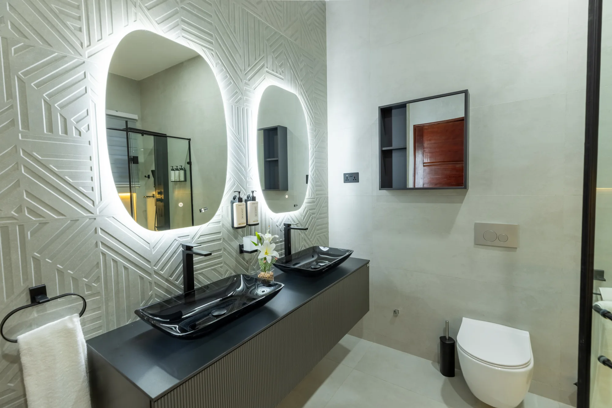 Residence One black double vanity and textured wall detail