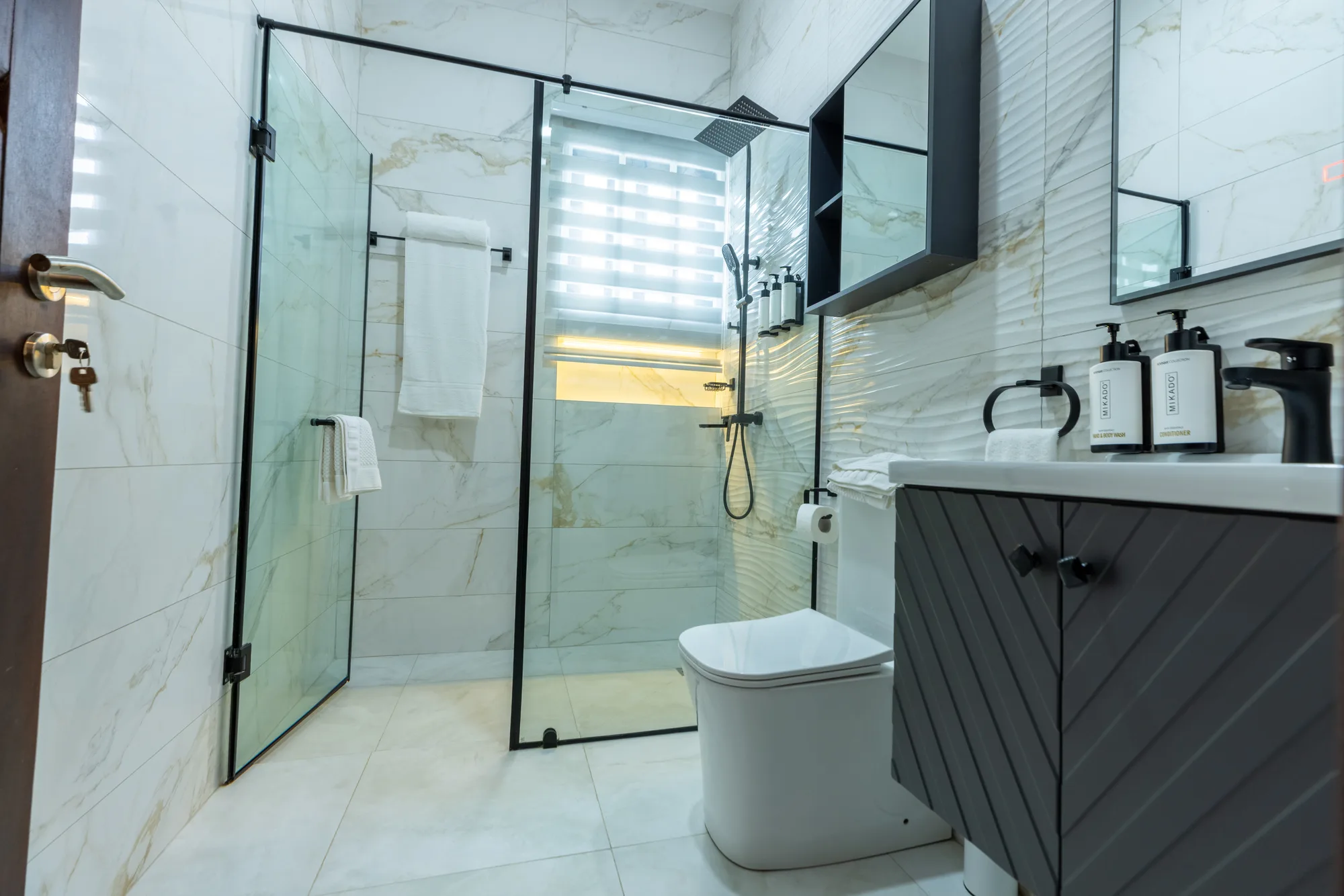 Residence Two ensuite bathroom with glass shower and vanity