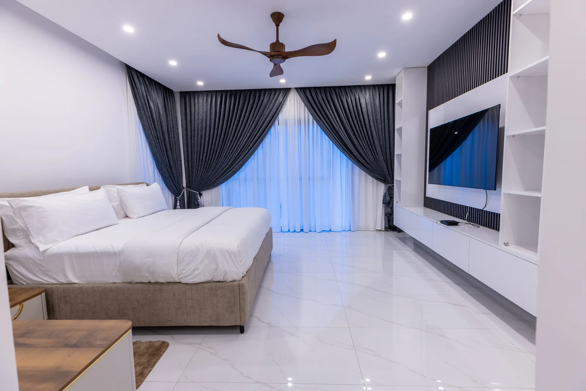 Private bedroom with wood wardrobes and layered curtains