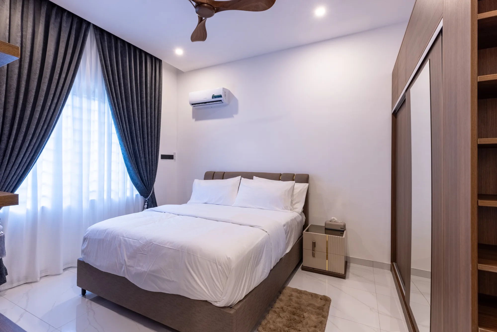 Bright bedroom with full-height curtains
