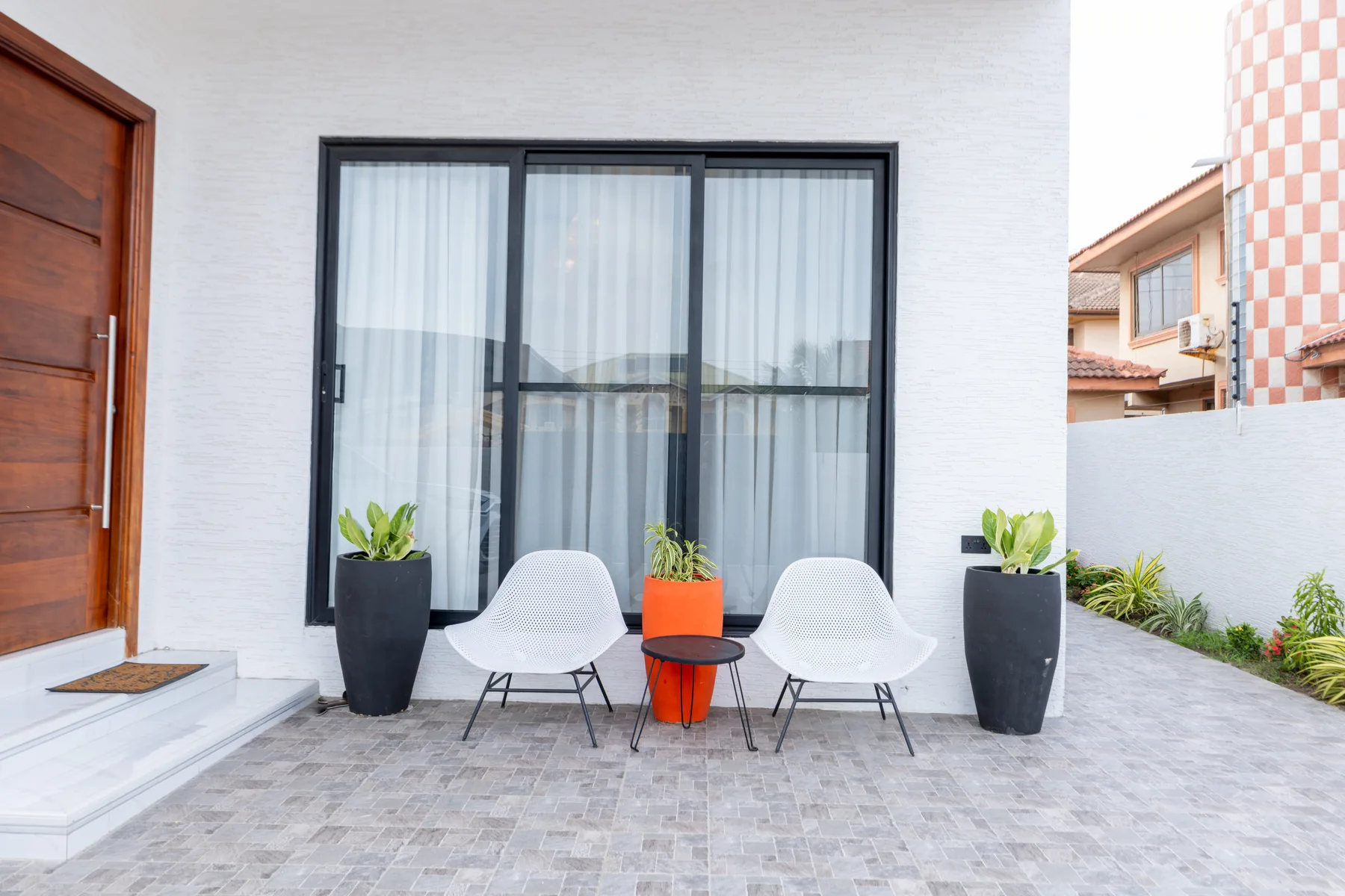 Exterior sitting area by the residence entrance