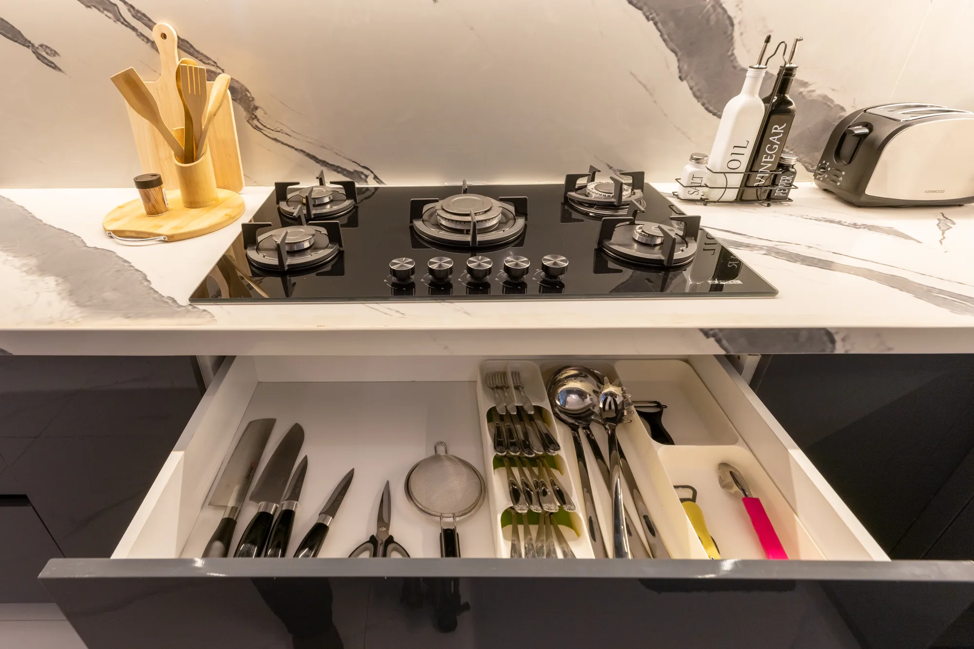 Residence One cooktop and utensil drawer detail